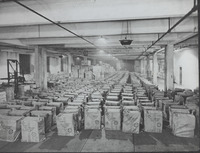 Boxes  in a warehouse with cloth covers with Red Cross emblem